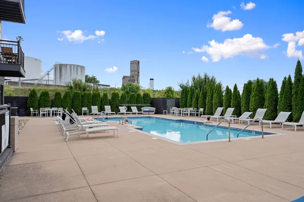 a view of a patio with swimming pool and outdoor seating