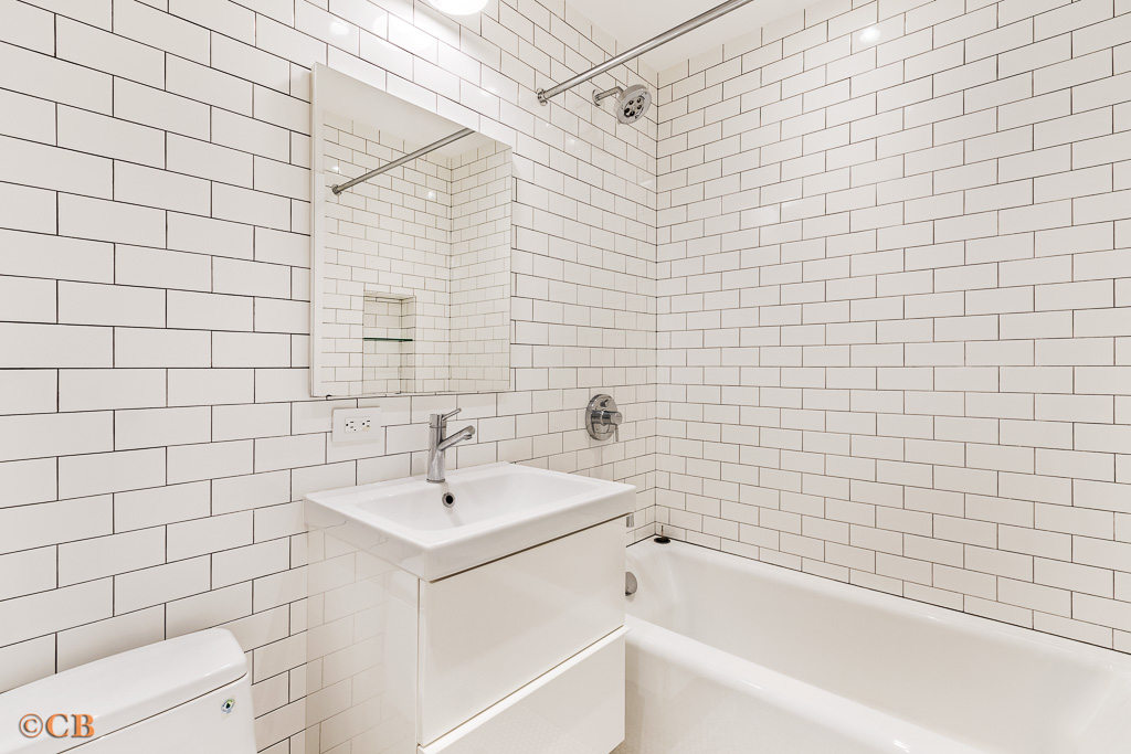 115 Lincoln Place, Unit 1 Brooklyn, NY 11217 - Photo 4 of 6 a bathroom with a sink a toilet and shower