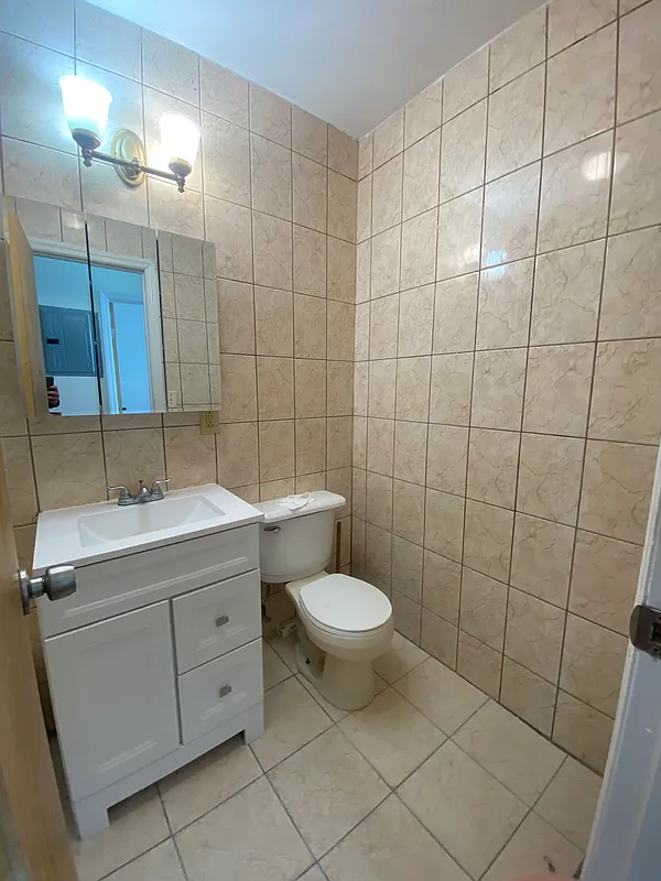 1251 Saint Marks Avenue, Unit 2 Brooklyn, NY 11213 - Photo 5 of 5 a bathroom with a toilet sink and shower