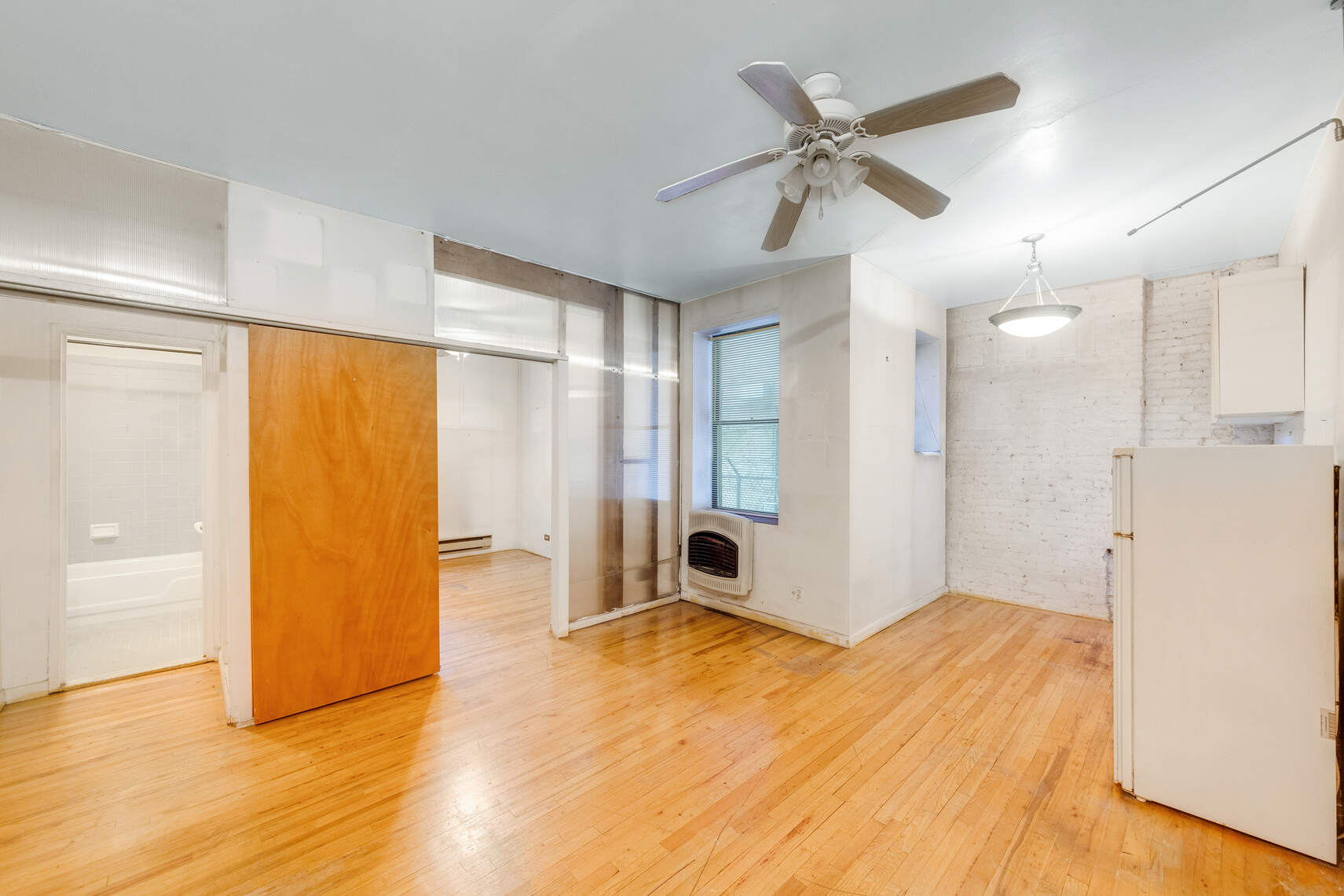 604 Riverside Drive, Unit 1B Manhattan, NY 10031 - Photo 2 of 14 a view of a livingroom with wooden floor and a ceiling fan