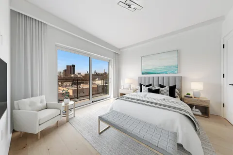 a bedroom with a bed couch and window