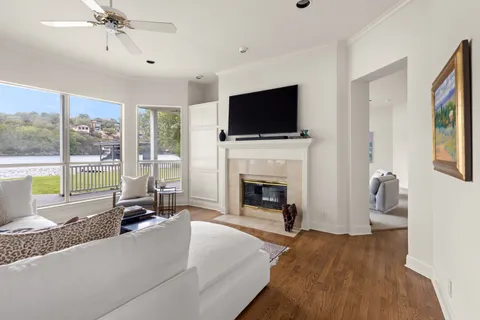 a living room with furniture a flat screen tv and a fireplace