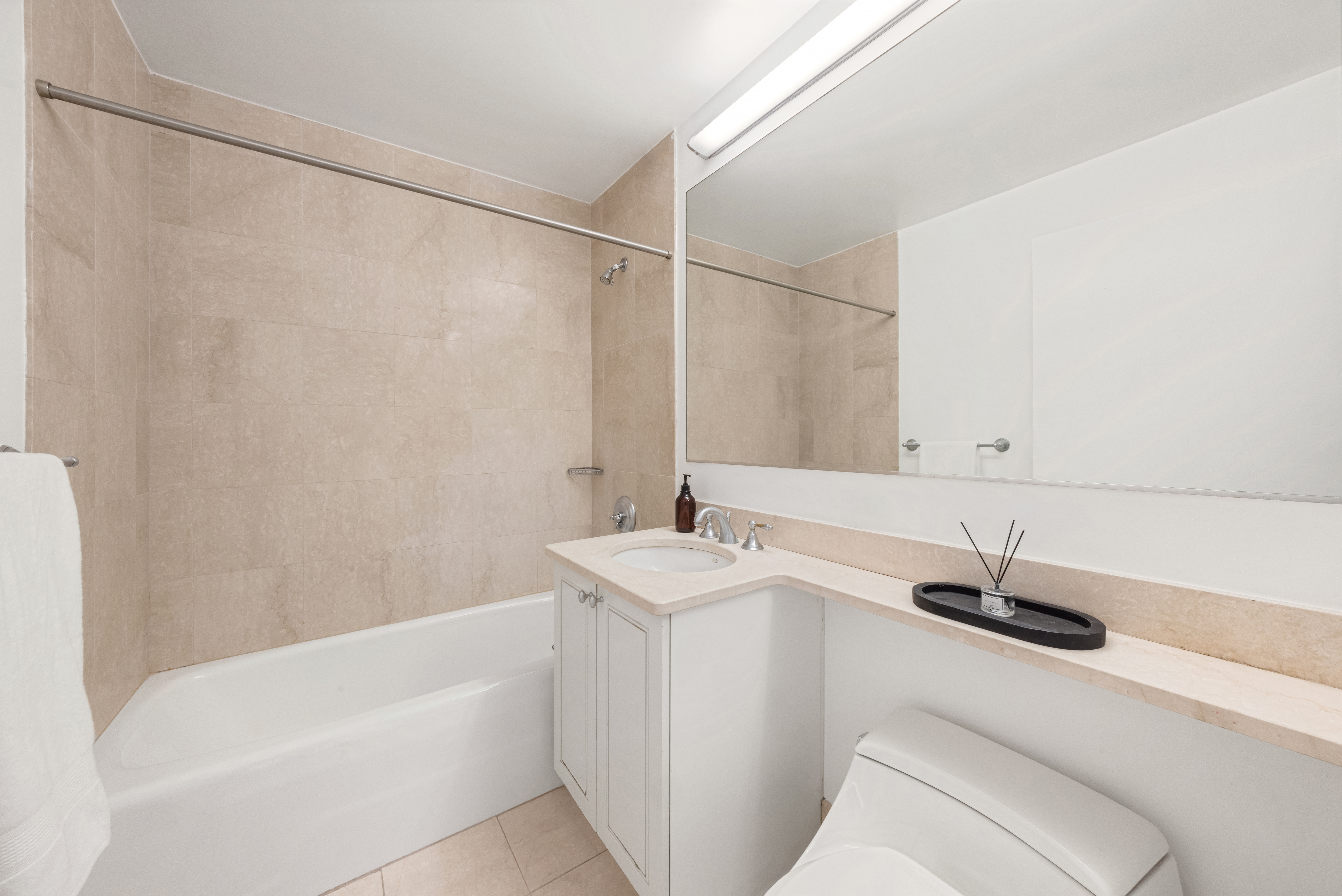 1760 2nd Avenue, Unit 30C Manhattan, NY 10128 - Photo 12 of 21 a bathroom with a sink and a bathtub