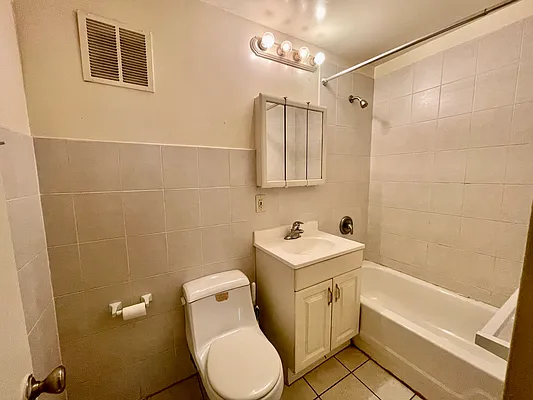 1105 1st Avenue, Unit 9 Manhattan, NY 10065 - Photo 6 of 8 a bathroom with a sink a toilet and shower