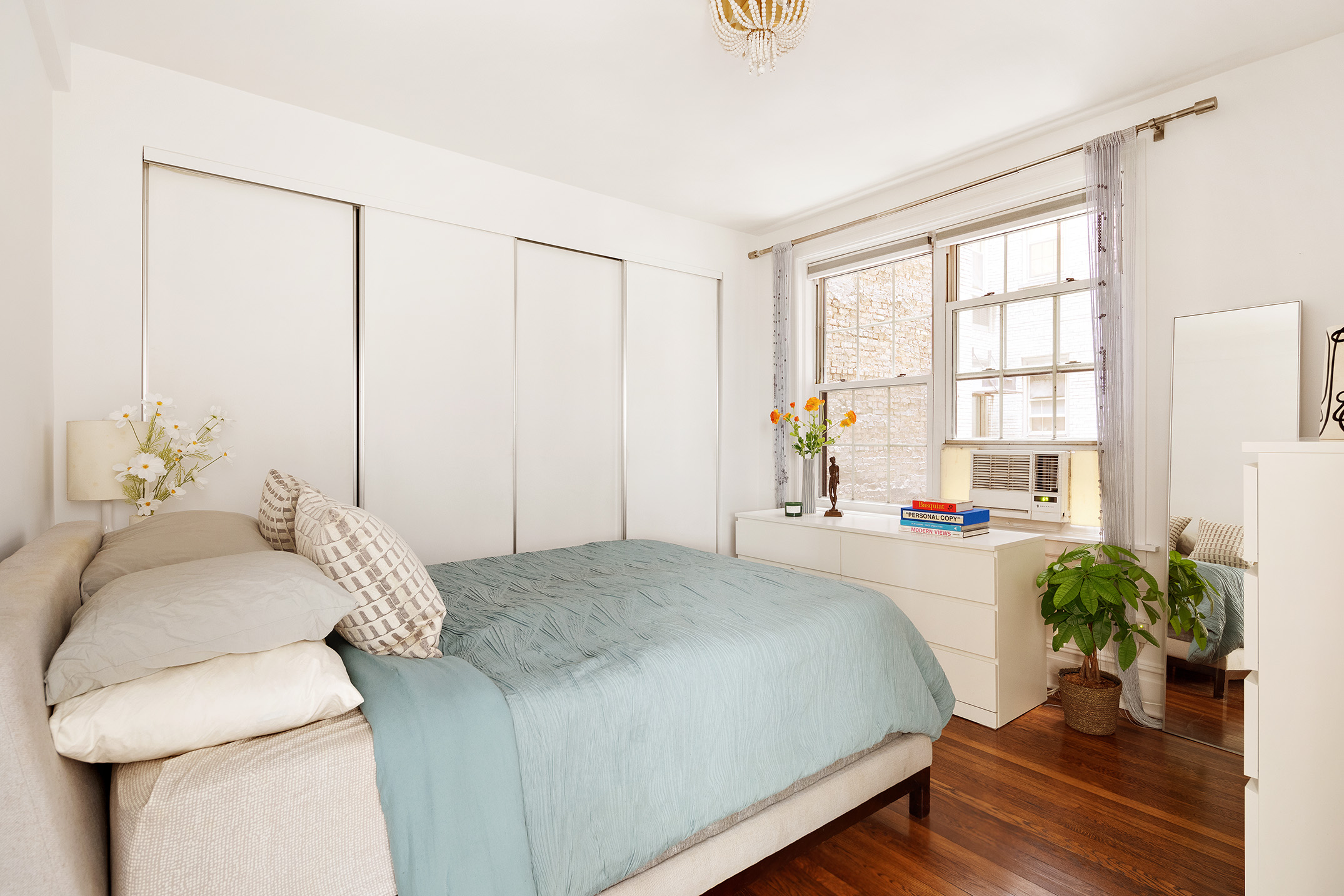 41 5th Avenue, Unit 2F Manhattan, NY 10003 - Photo 5 of 12 a bedroom with a bed and wooden floor
