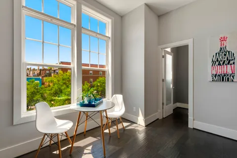 a view of a dining room with furniture window and outside view