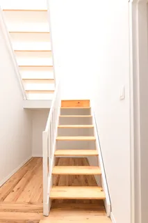 a view of staircase with white walls