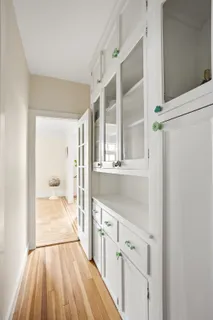 a view of a hallway with wooden floor and staircase