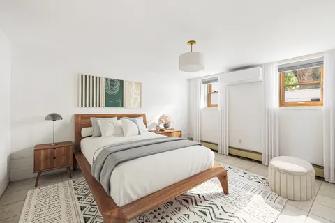 a bedroom with a bed and a lamp