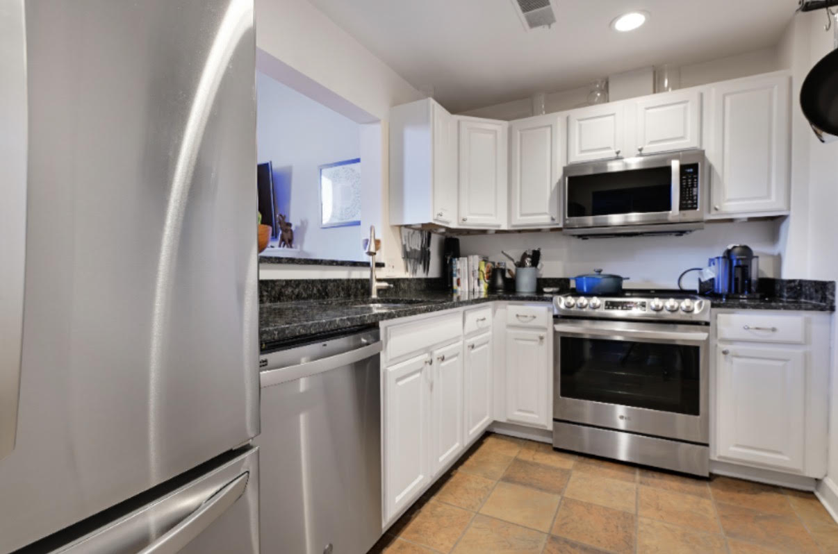 1715 15th Street Northwest, Unit 101 Washington, DC 20009 - Photo 4 of 23 a kitchen with stainless steel appliances granite countertop a sink and a stove top oven