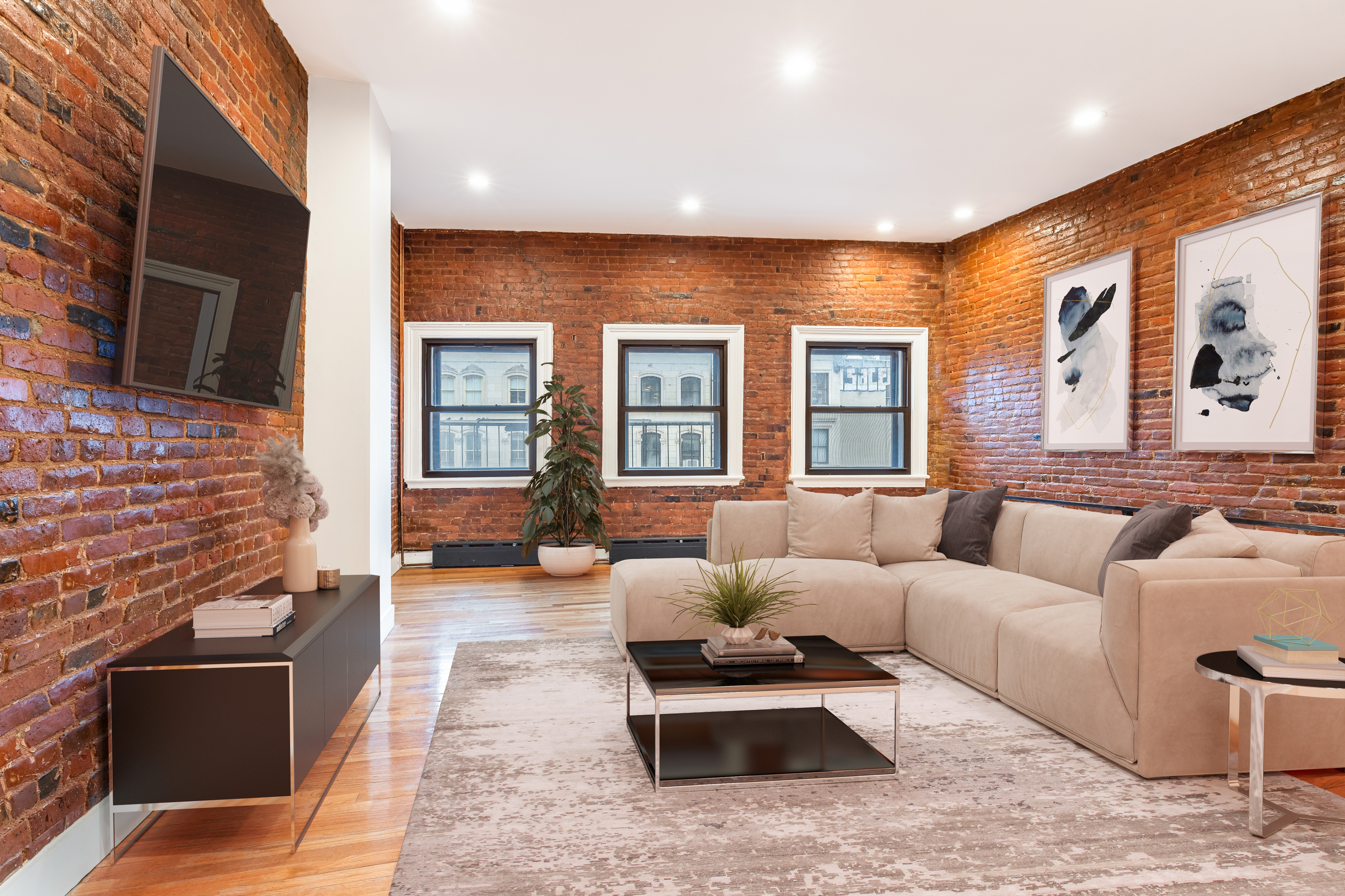 61 Lispenard Street, Unit 4 Manhattan, NY 10013 - Photo 5 of 8 a living room with furniture fireplace and flat screen tv