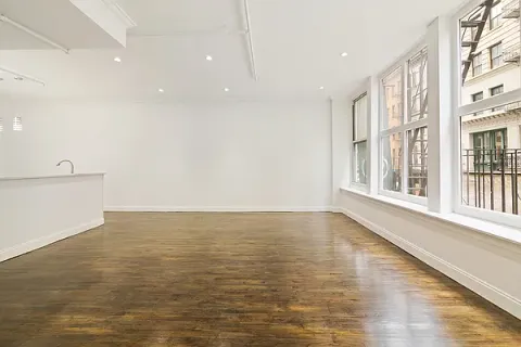 a view of an ocean & mountain view in an empty room