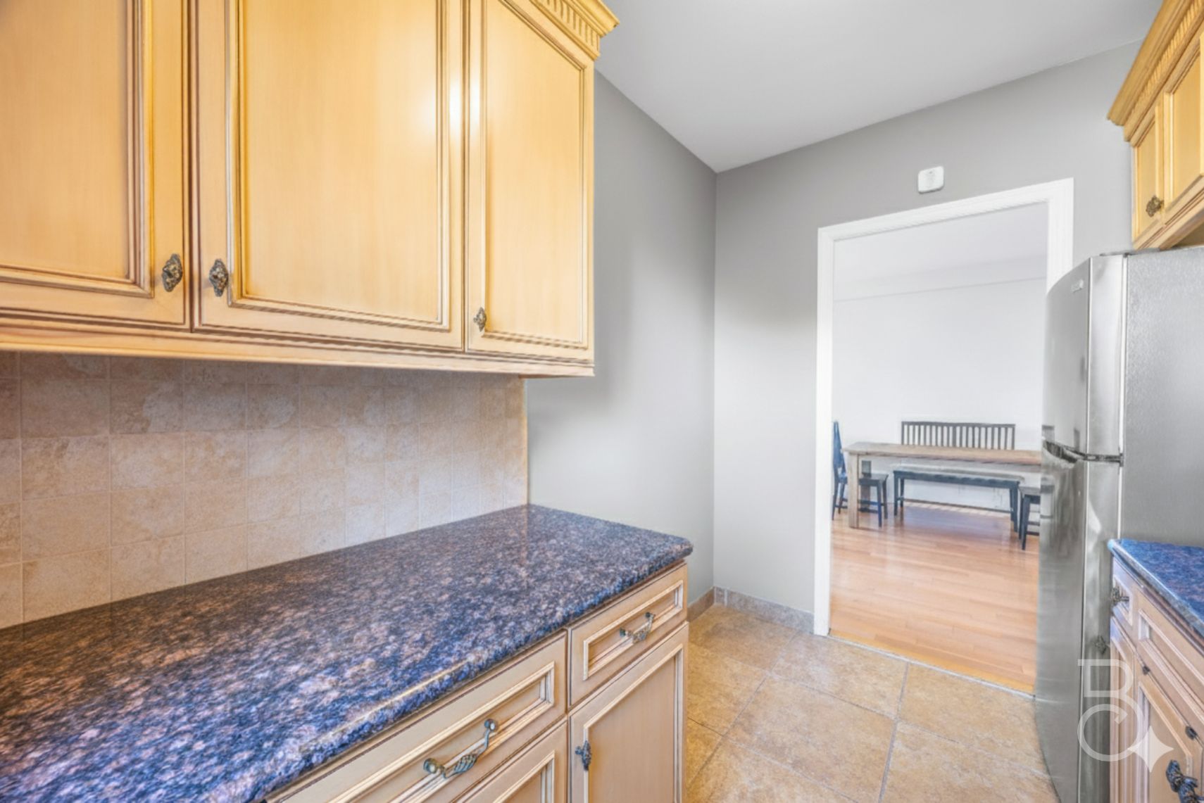 99-52 66th Road, Unit 5D Queens, NY 11374 - Photo 9 of 13 a kitchen with granite countertop a refrigerator and a sink