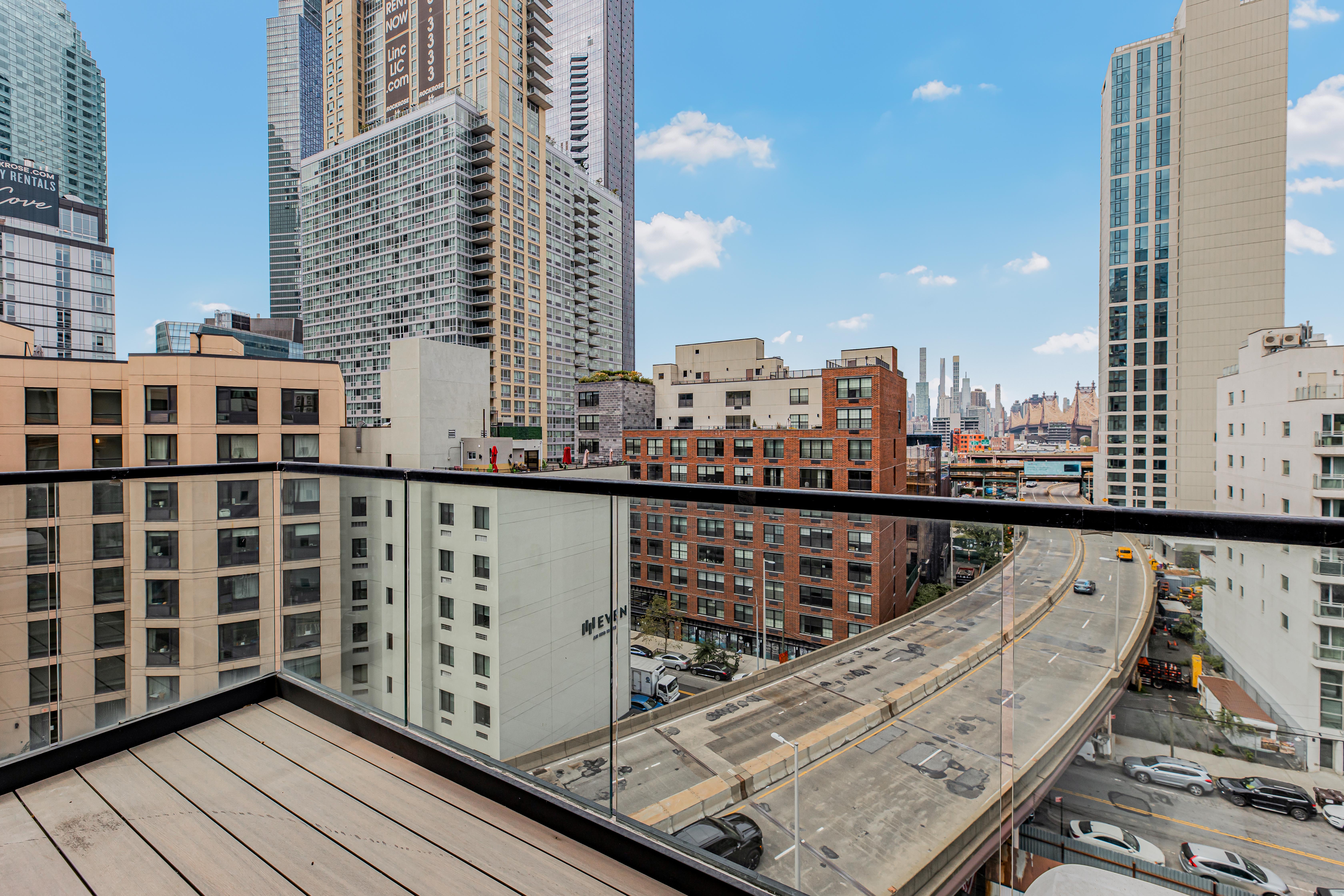 42-50 27th Street, Unit 9C Queens, NY 11101 - Photo 20 of 32 a view of balcony with wooden floor and city view
