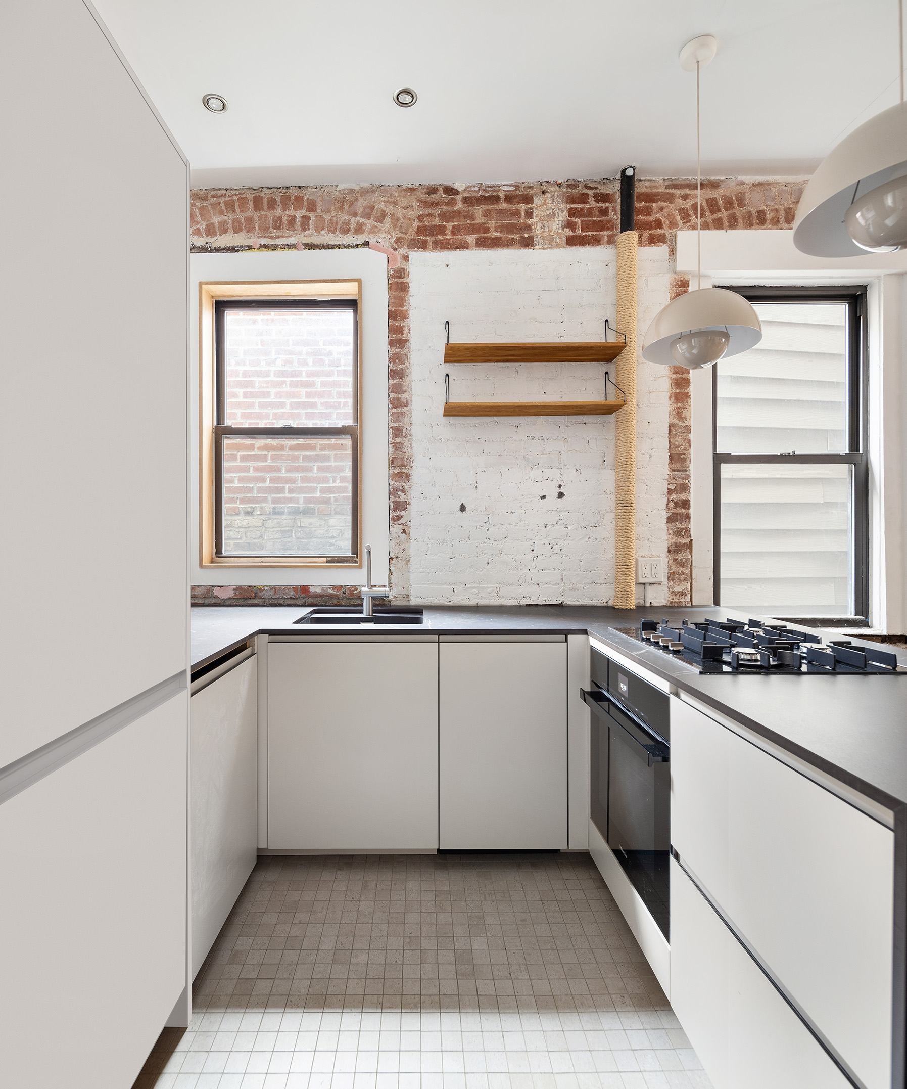 32 Jones Street, Unit 2A Manhattan, NY 10014 - Photo 5 of 7 a kitchen with a sink stove and cabinets