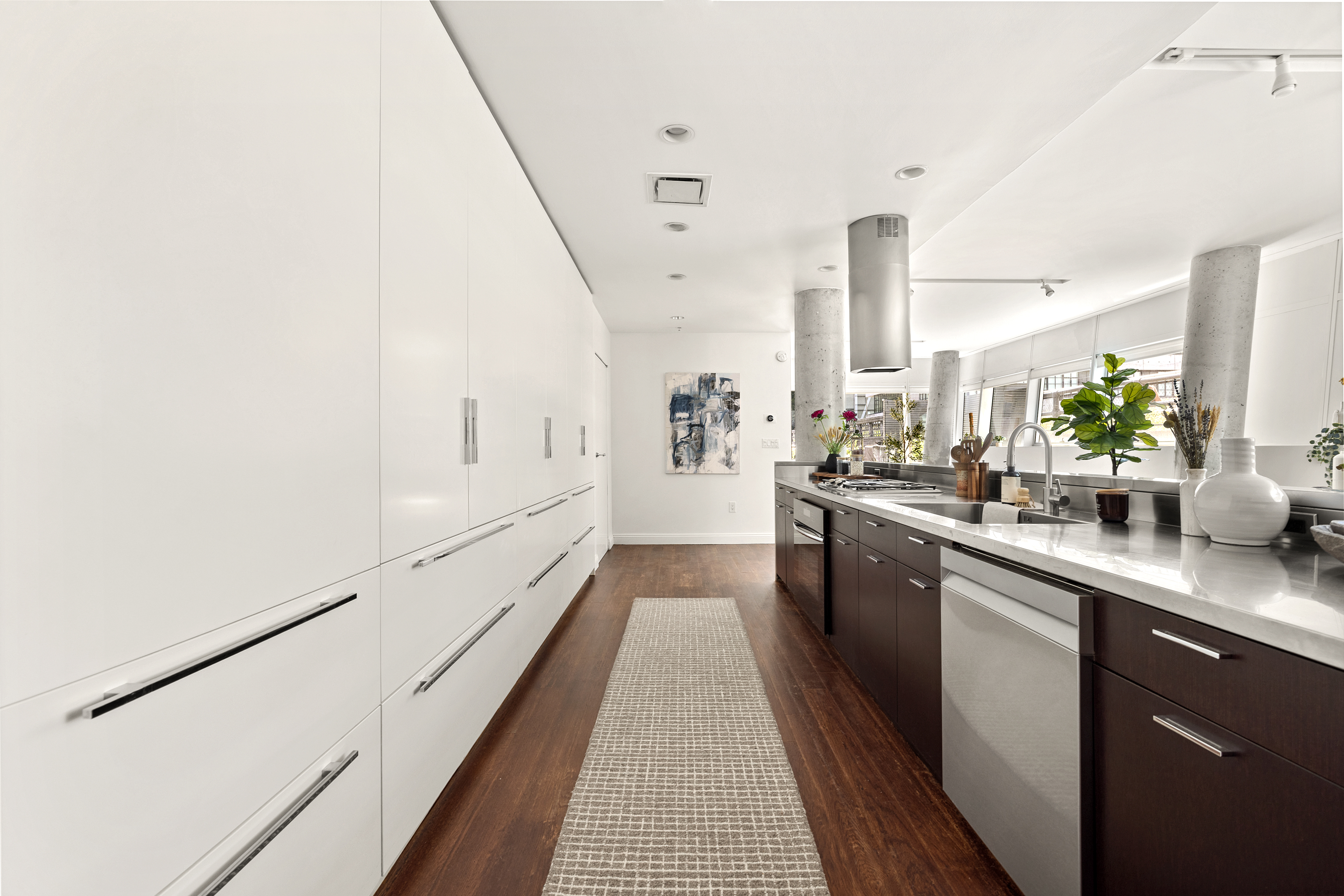 245 10th Avenue, Unit 2W Manhattan, NY 10001 - Photo 6 of 16 a large kitchen with a lot of counter space and wooden floor