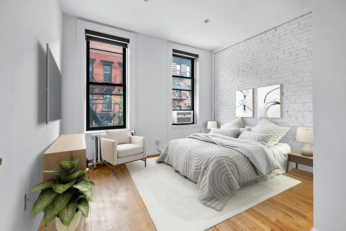 a bedroom with a bed window and a couch