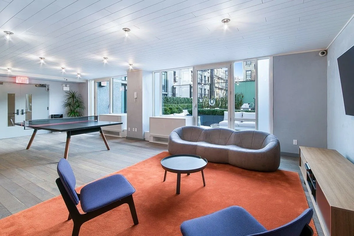 385 1st Avenue, Unit 10G Manhattan, NY 10010 - Photo 17 of 22 a living room with furniture and a potted plant