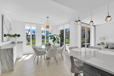 a dining room with furniture a chandelier and wooden floor