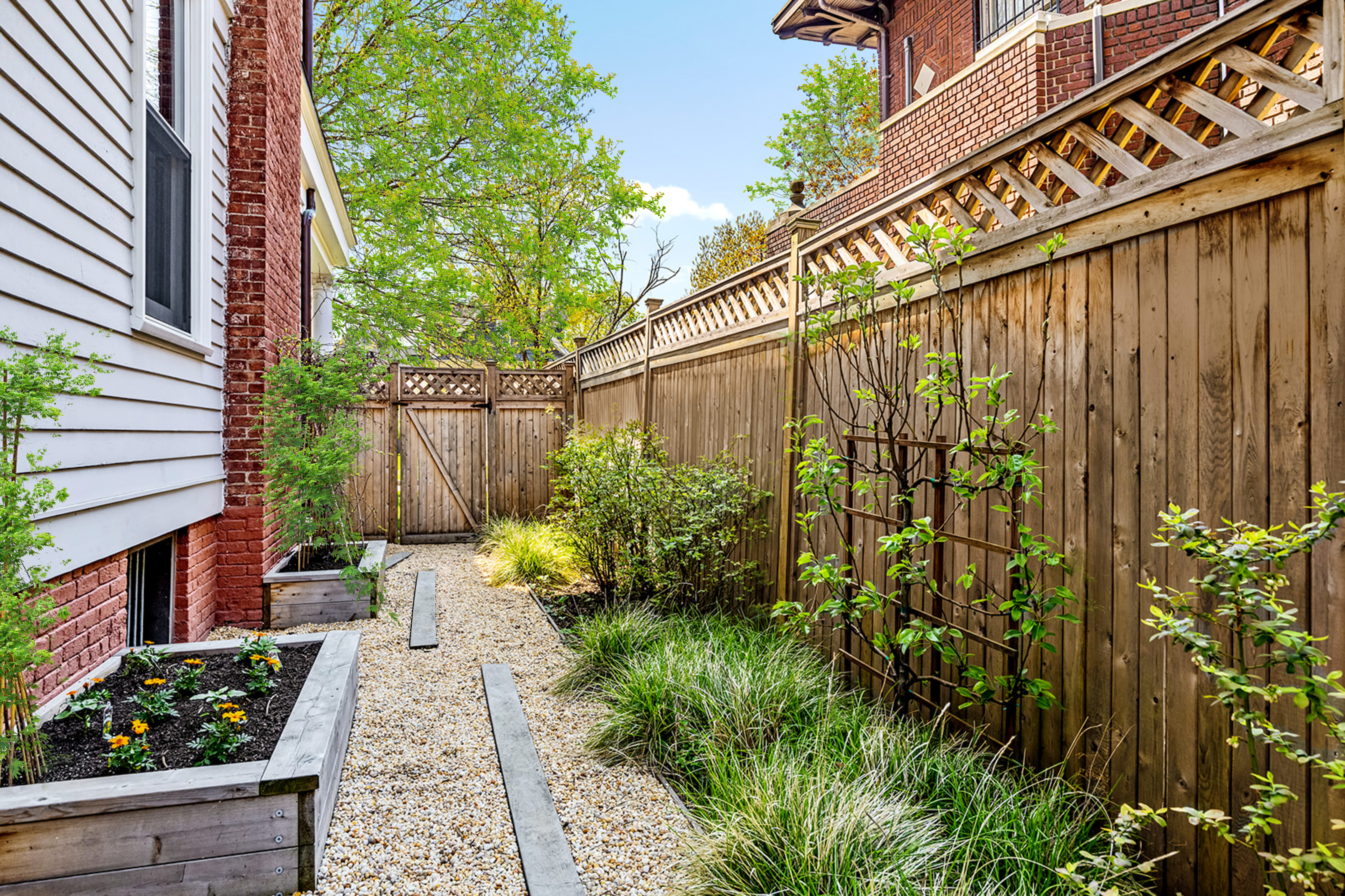 1221 Albemarle Road Brooklyn, NY 11218 - Photo 22 of 45 a street view with wooden fence and flowers