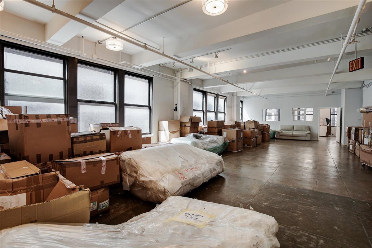 146 West 29th Street, Unit 9W Manhattan, NY 10001 - Photo 5 of 10 a living room with furniture and a large window
