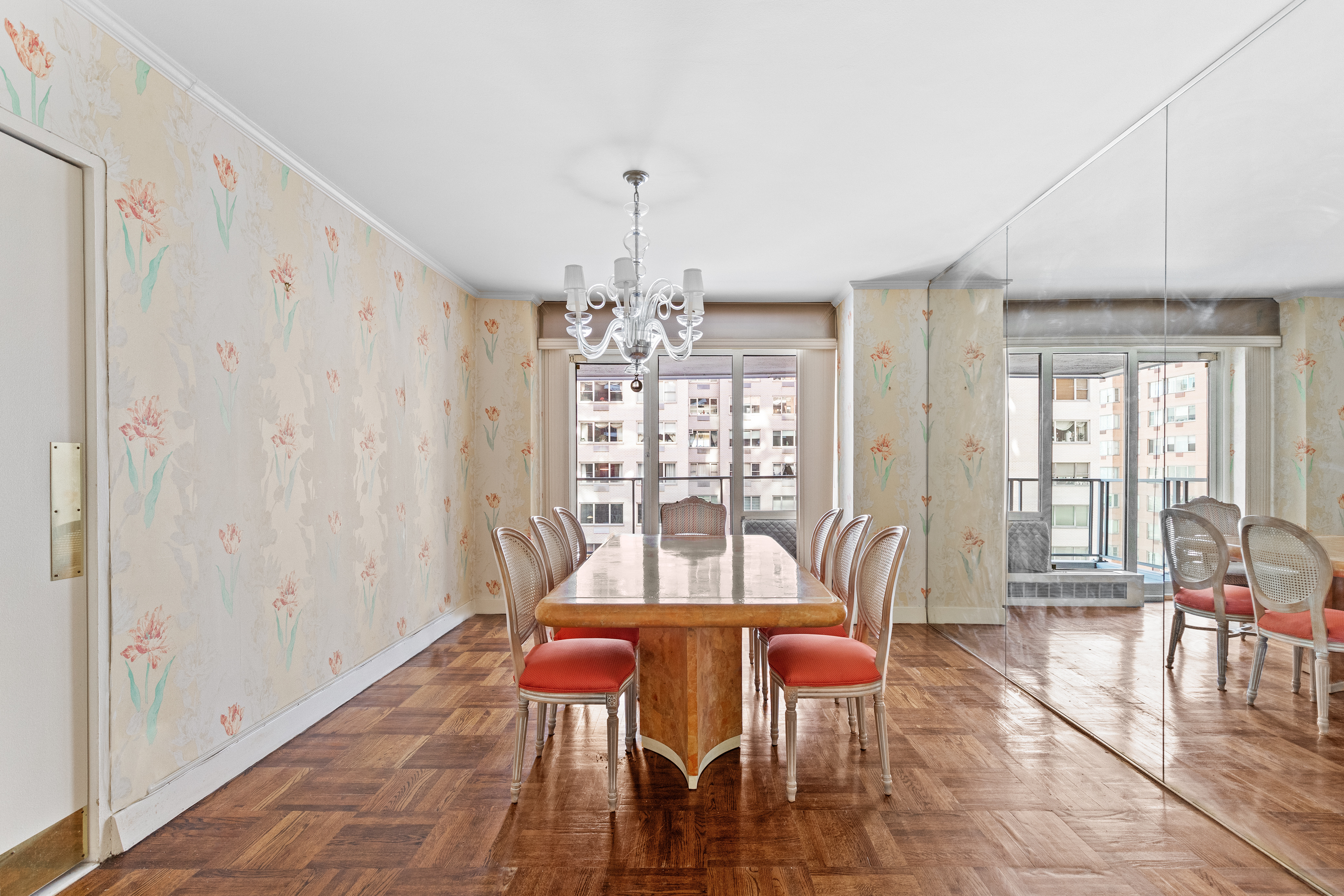 50 Sutton Place South, Unit 7A Manhattan, NY 10022 - Photo 7 of 16 a dining room with furniture a chandelier and wooden floor