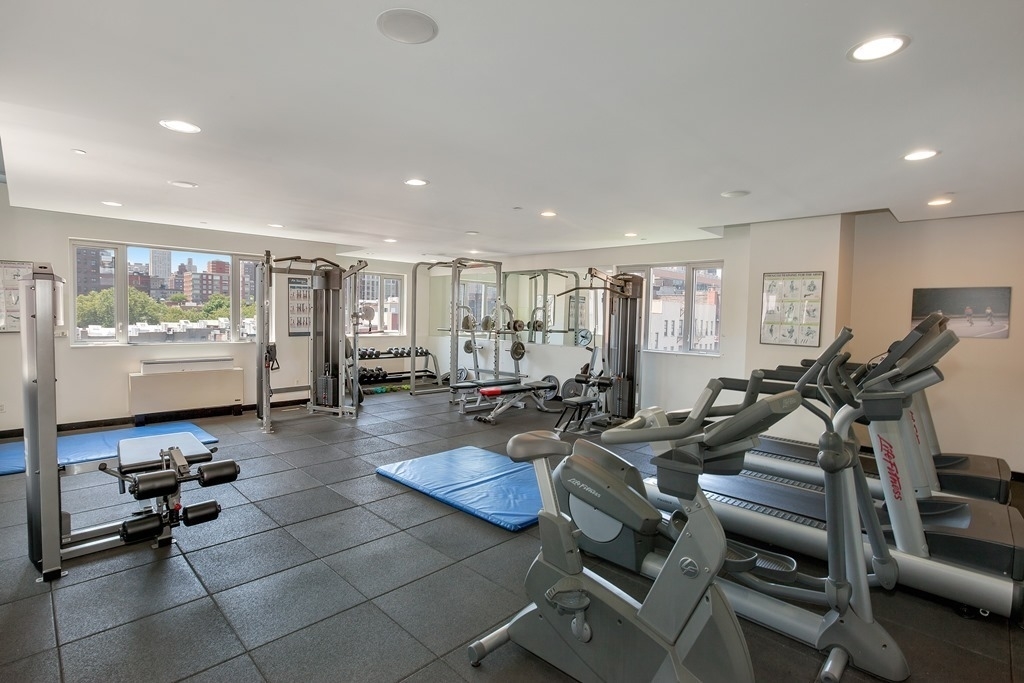 1810 3rd Avenue, Unit A7C Manhattan, NY 10029 - Photo 7 of 12 a gym room with lots of chairs and wooden floor