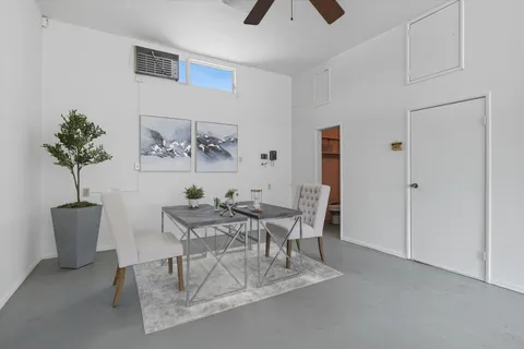 a room with stainless steel appliances kitchen island granite countertop a refrigerator and a stove