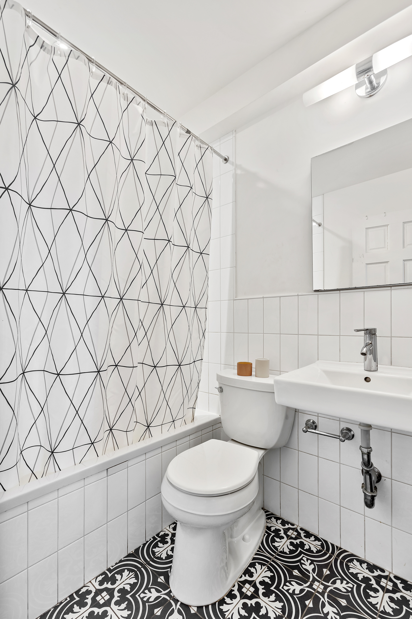 595 Madison Street, Unit GARDEN Brooklyn, NY 11221 - Photo 5 of 9 a bathroom with a sink toilet and shower