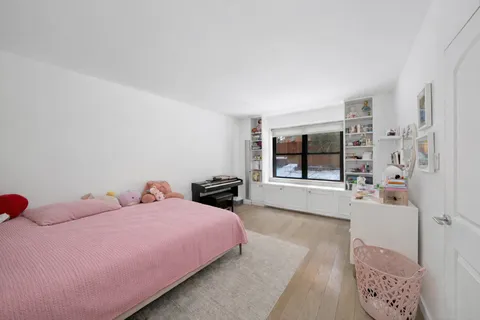 a bedroom with furniture and a large window