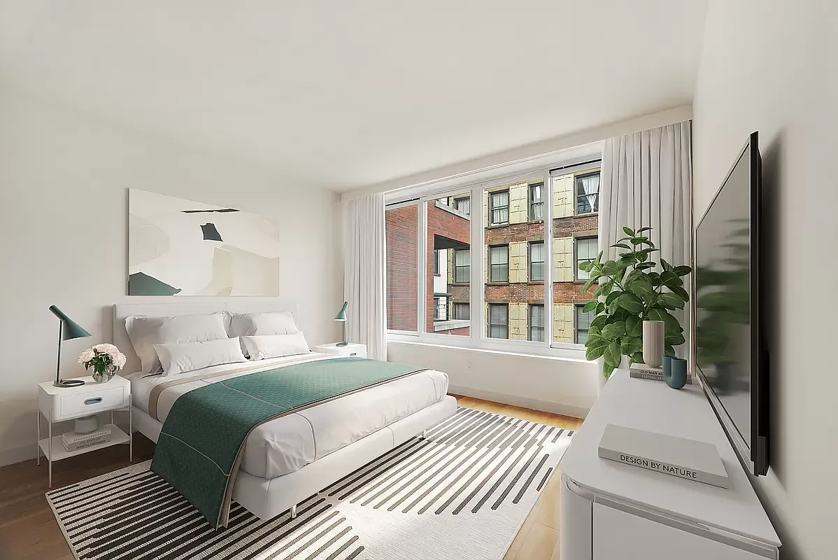 a bedroom with a bed and a large window