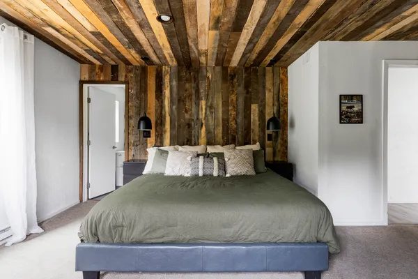 a bed sitting in a bedroom next to a window