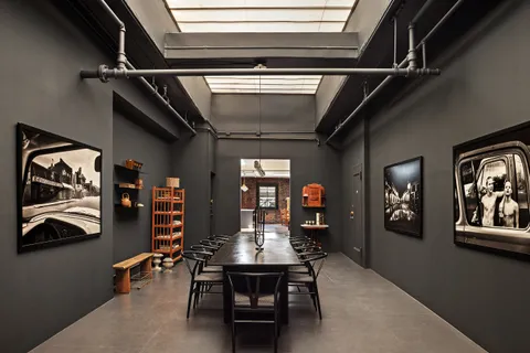 a view of a hallway with furniture and window