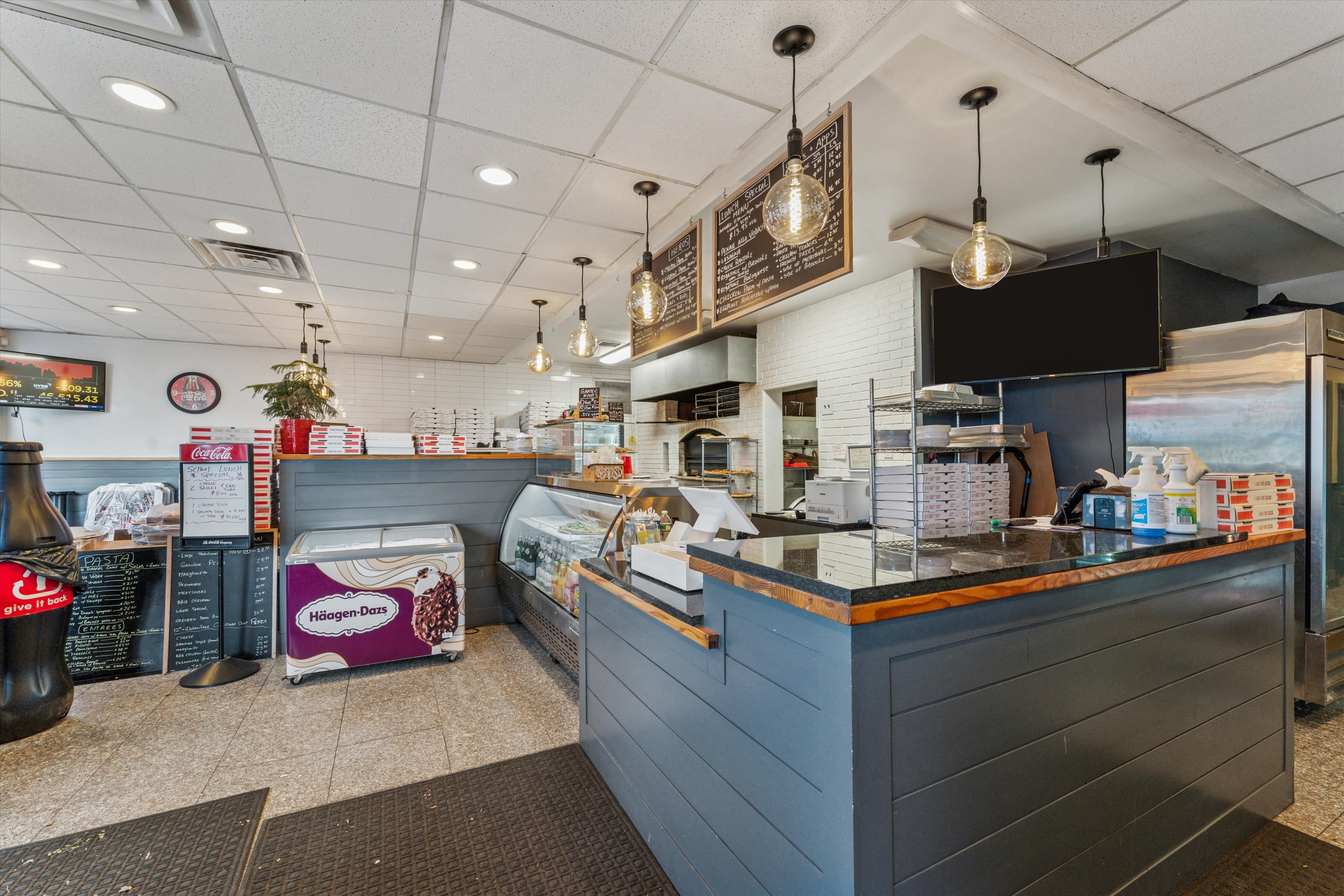 13500 Main Road Mattituck, NY 11952 - Photo 4 of 10 a kitchen filled with stainless steel appliances kitchen island granite countertop a table and chairs