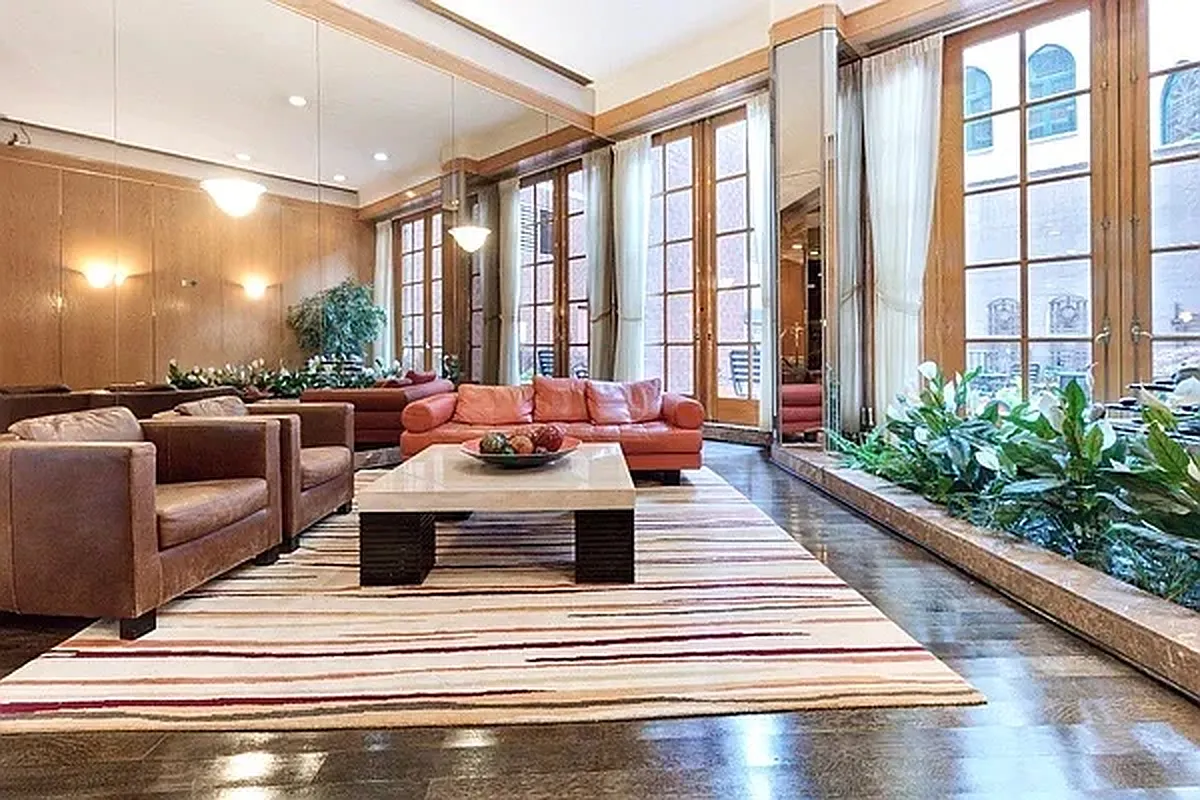 330 East 75th Street, Unit 4D Manhattan, NY 10021 - Photo 8 of 9 a living room with furniture and a large window