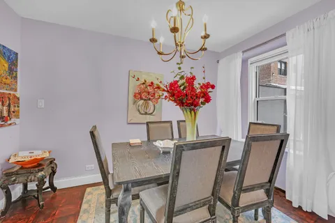 a view of a dining room with furniture wooden floor and a chandelier