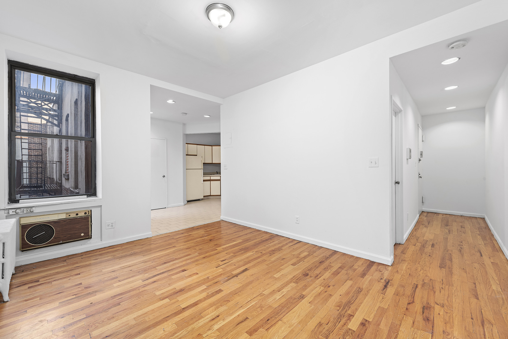 1716 2nd Avenue, Unit 5B Manhattan, NY 10128 - Photo 1 of 6 a view of empty room with a fireplace and wooden floor