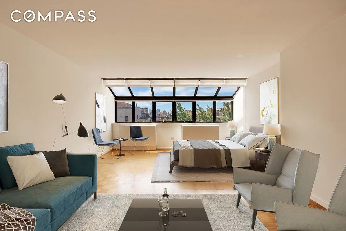 a living room with furniture wooden floor and a large window