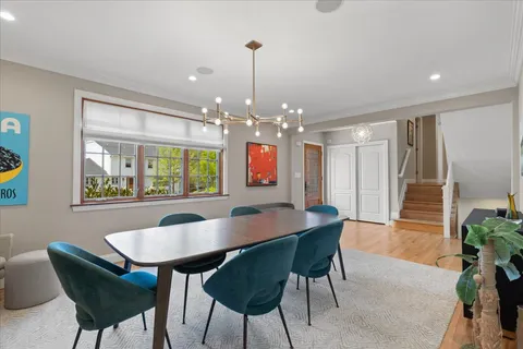 a kitchen with a stove a sink dishwasher a kitchen island with wooden cabinets and wooden floor