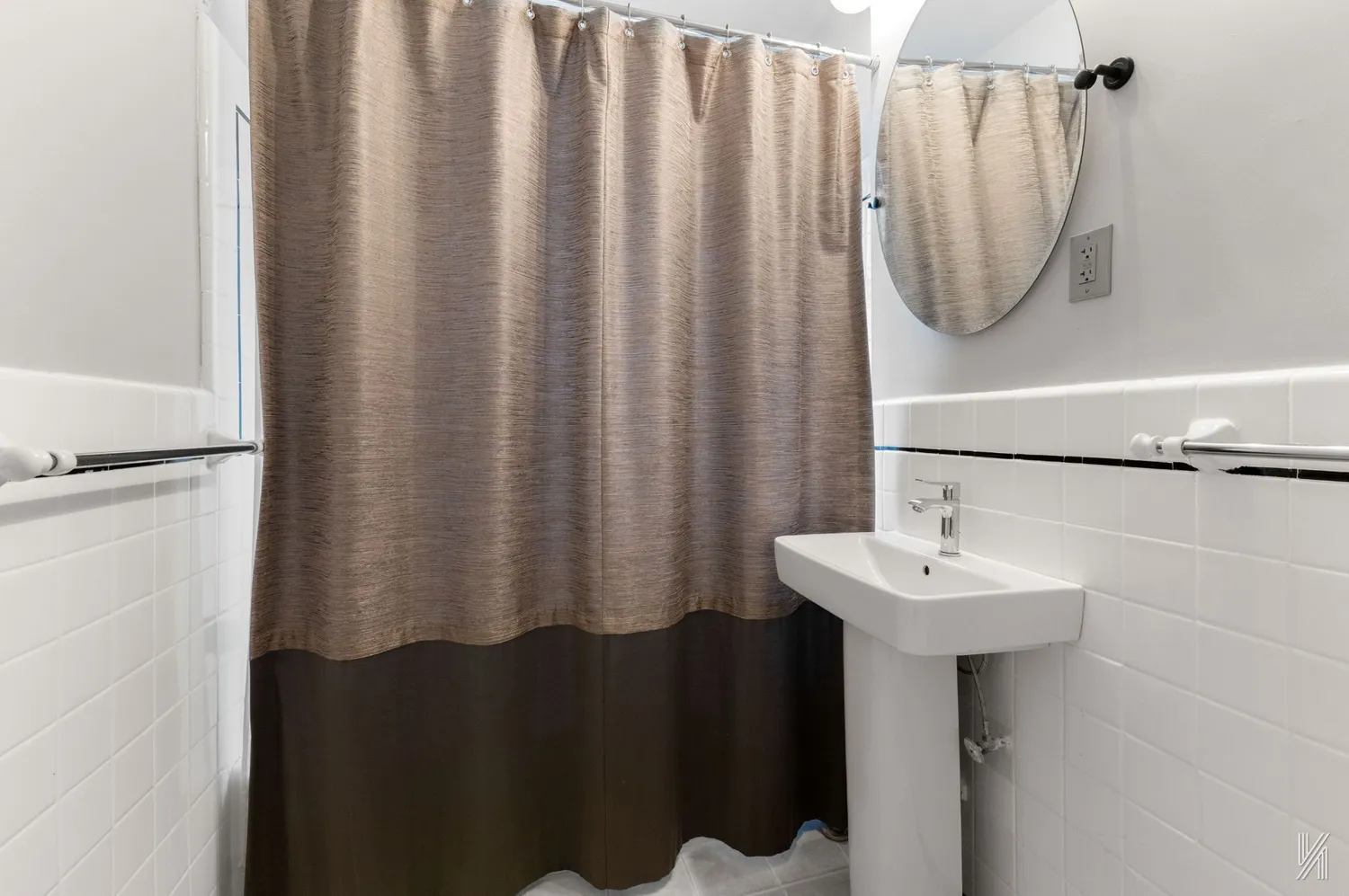 a bathroom with a sink a mirror and a shower curtain