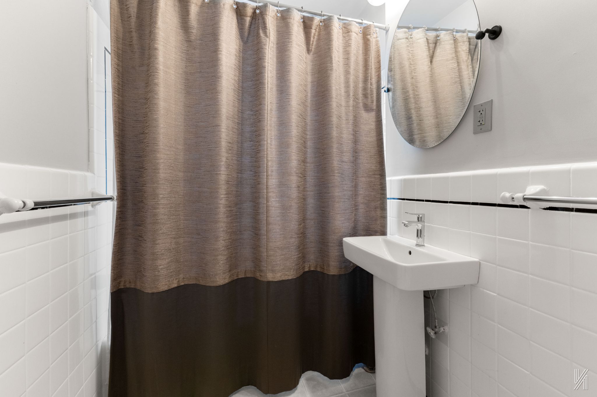 25-40 31st Avenue, Unit 6F Queens, NY 11106 - Photo 15 of 19 a bathroom with a sink a mirror and a shower curtain
