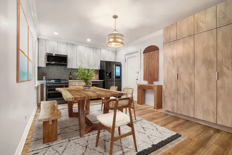 a view of a dining room with furniture window and wooden floor