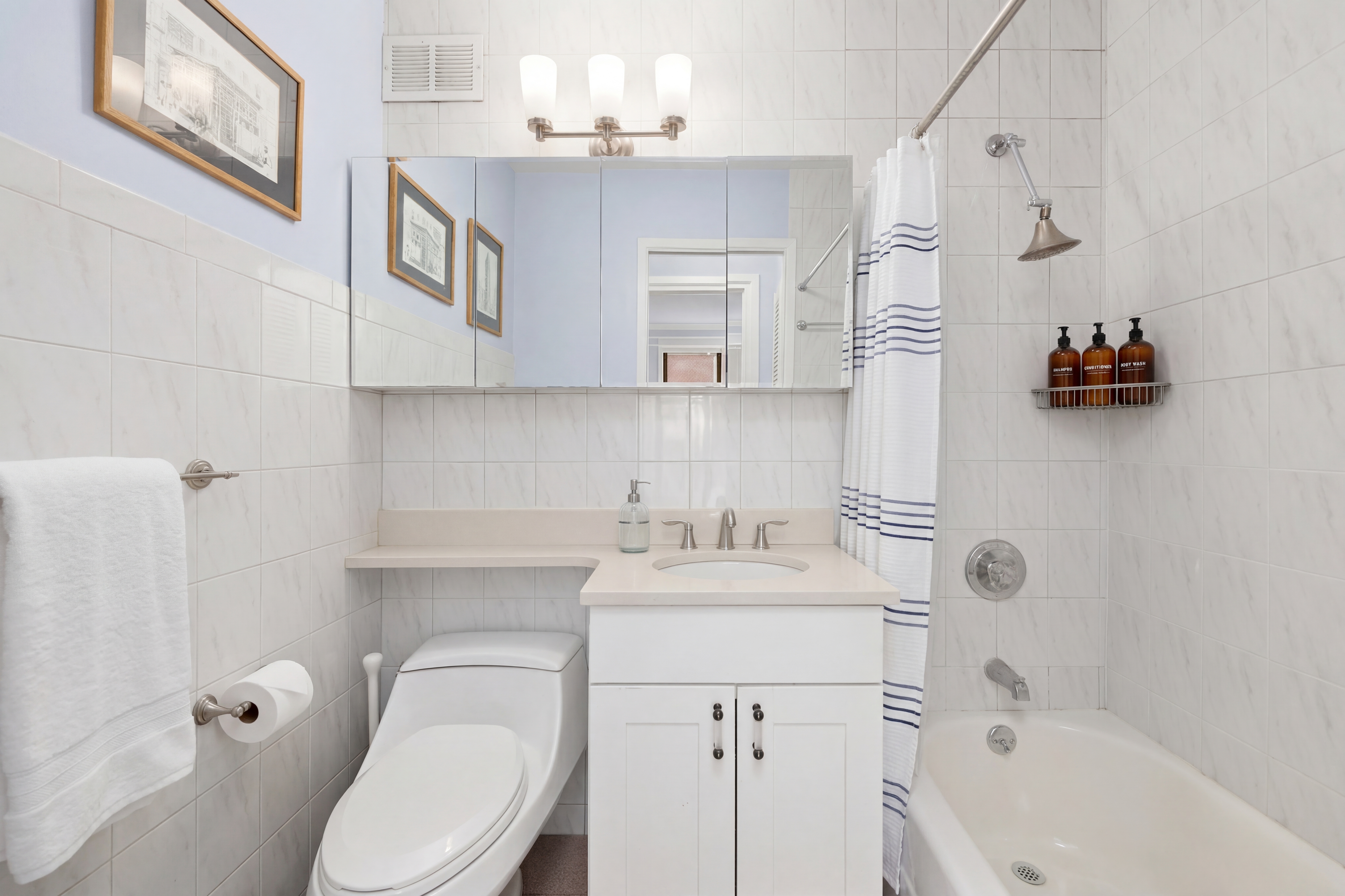 201 East 21st Street, Unit 2FG Manhattan, NY 10010 - Photo 8 of 10 a bathroom with a sink a toilet and shower