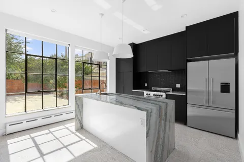 a kitchen with refrigerator and cabinets