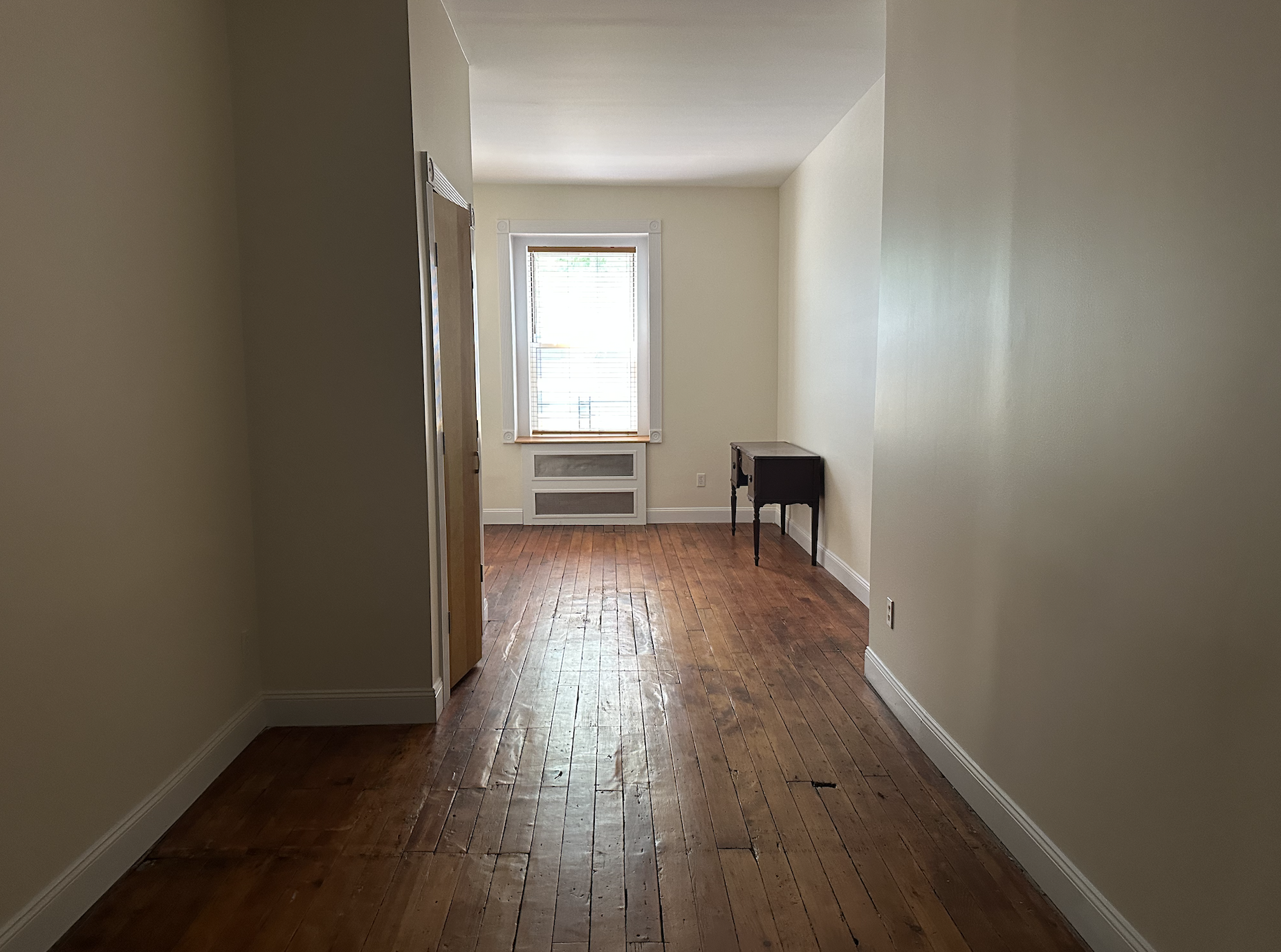 459 West 35th Street, Unit 1E Manhattan, NY 10001 - Photo 2 of 18 a view of a room with wooden floor and a window