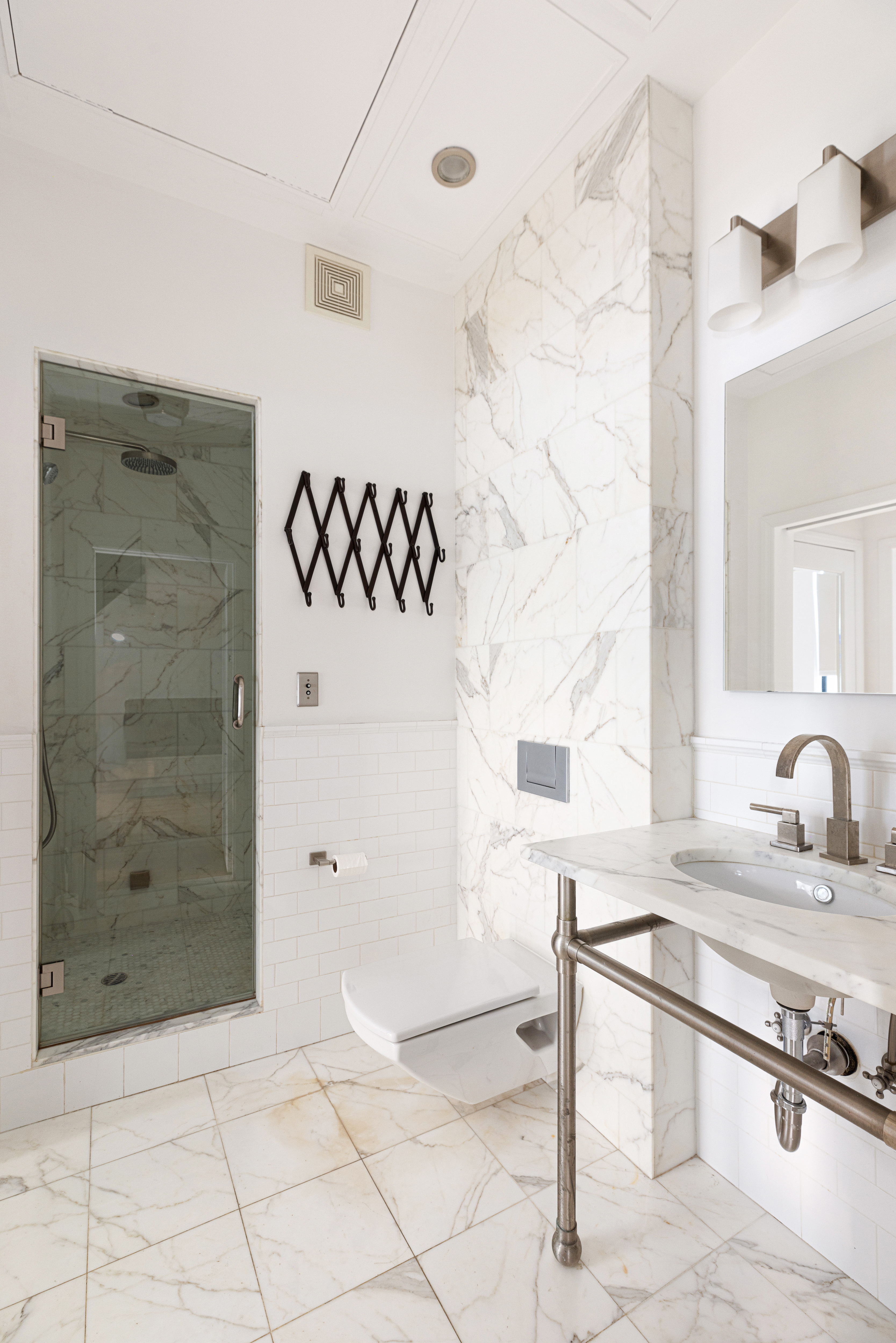 250 Mercer Street, Unit B203 Manhattan, NY 10012 - Photo 7 of 19 a bathroom with a sink and a mirror