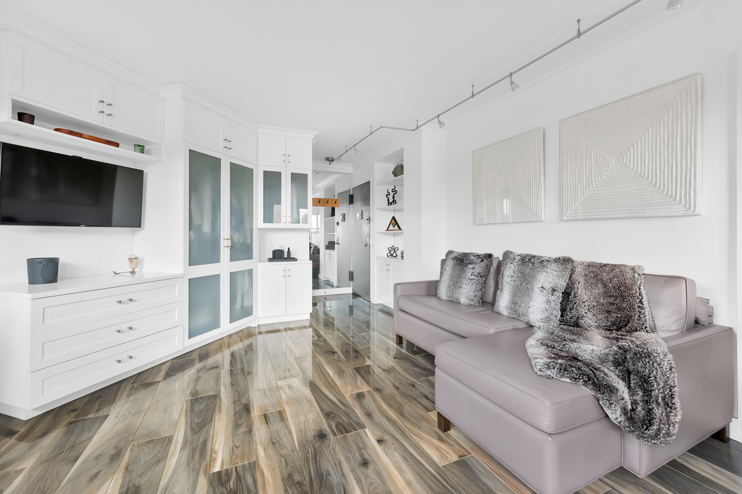 31 Jane Street, Unit 7A Manhattan, NY 10014 - Photo 2 of 11 a living room with furniture and a flat screen tv