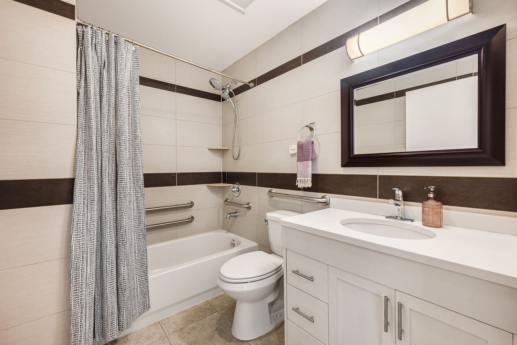 234 West 148th Street, Unit 5C Manhattan, NY 10039 - Photo 7 of 15 a bathroom with a toilet a sink a vanity and mirror