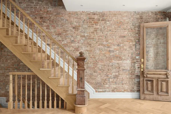 a view of staircase with large window and wooden floor