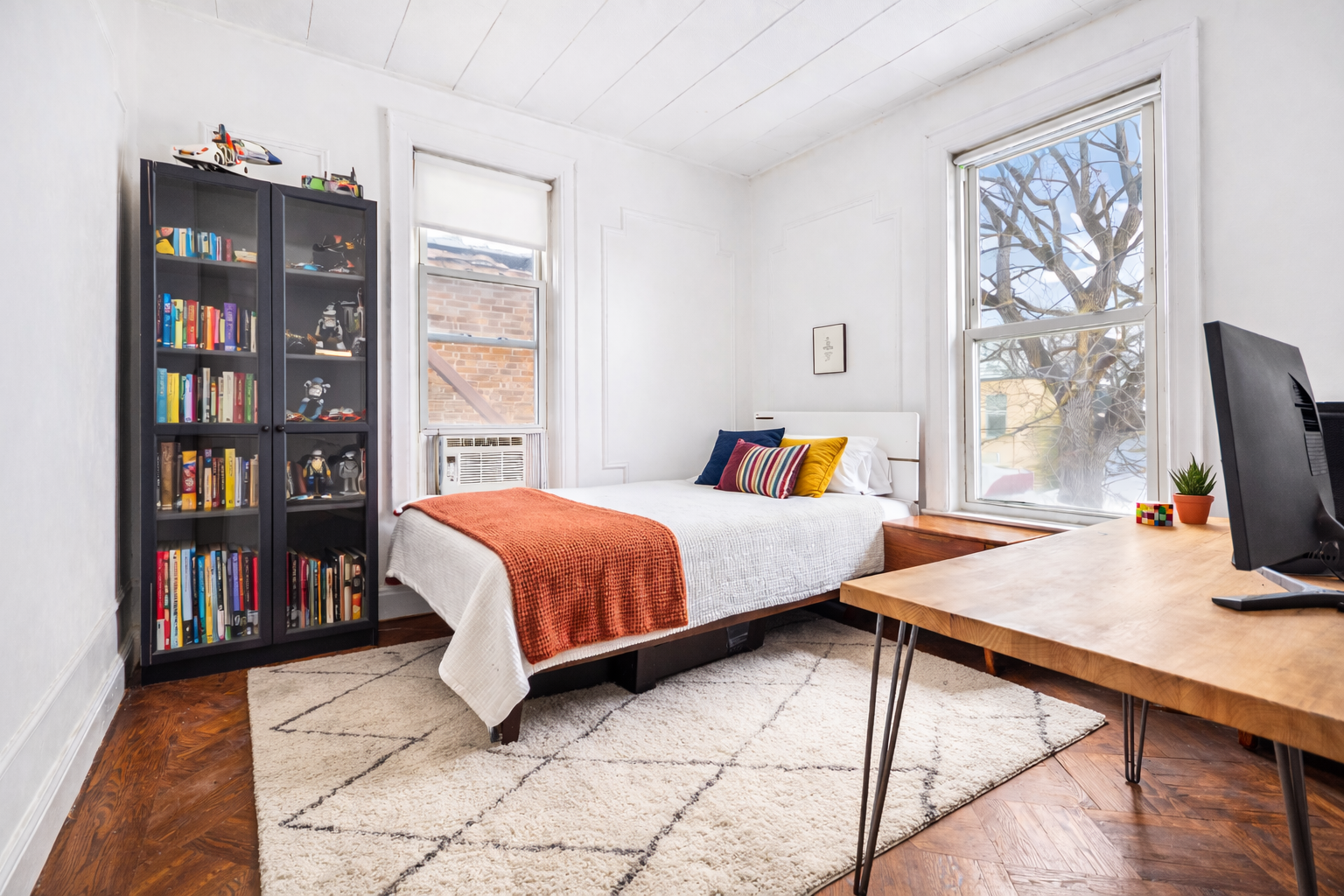 527 East 38th Street Brooklyn, NY 11203 - Photo 6 of 15 a bed sitting in a bedroom next to a book shelf